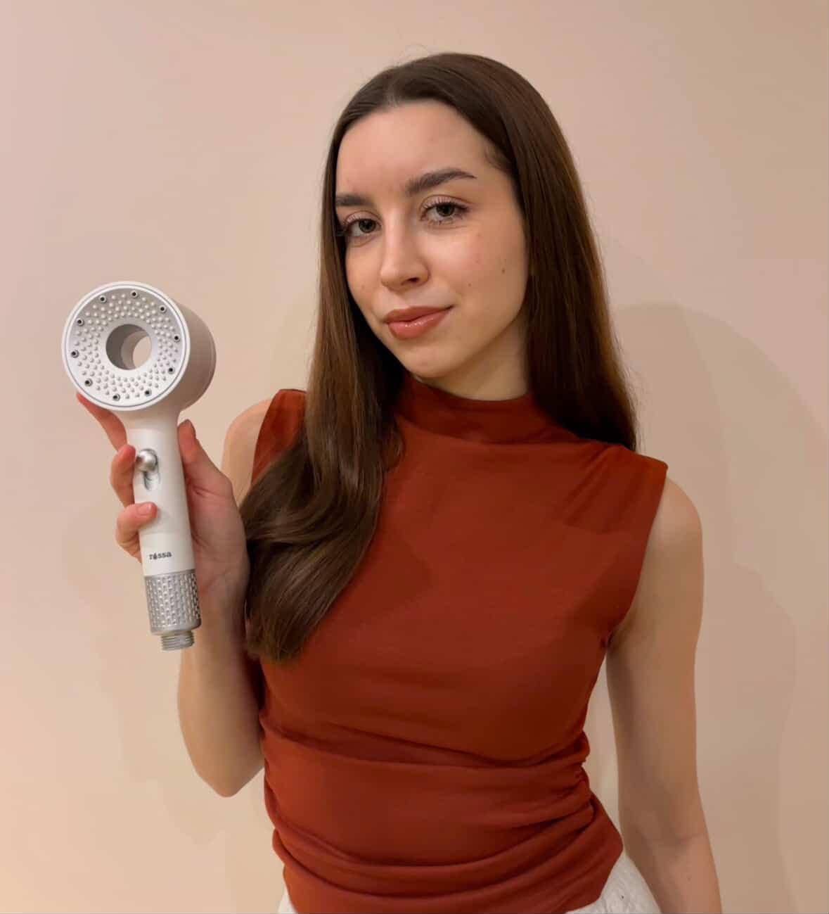 Girl with shower head in hand